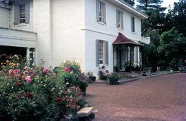 Visitor seated near front door and garden at Brickendon